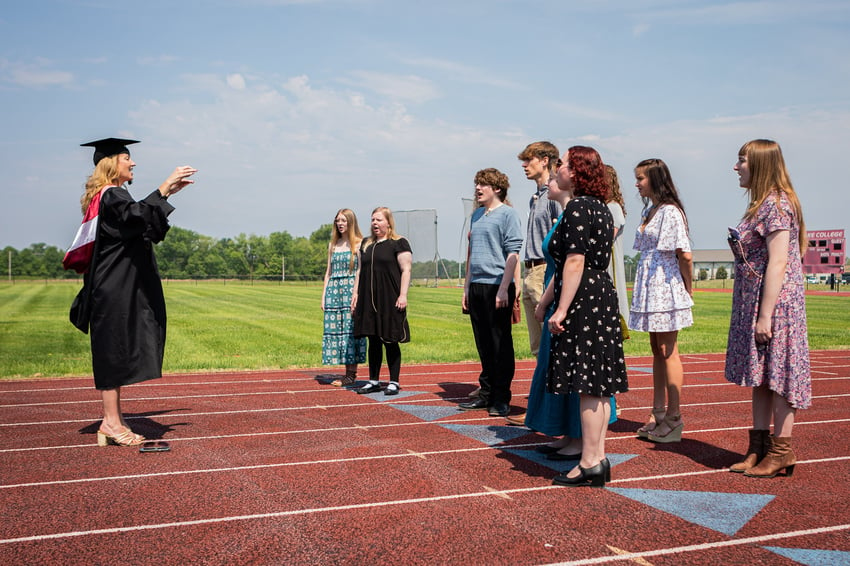 (Rend Lake College Music Professor, Sara Alstat-Sanders, leads the choir in the national anthem.)