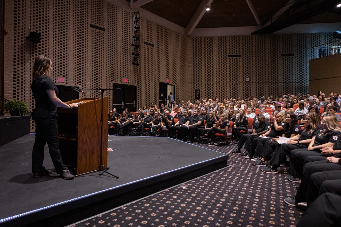 (Class Speaker and honors graduate, Erica McCormick, shares memorable moments and words of wisdom with the audience in the Rend Lake College Theater.)