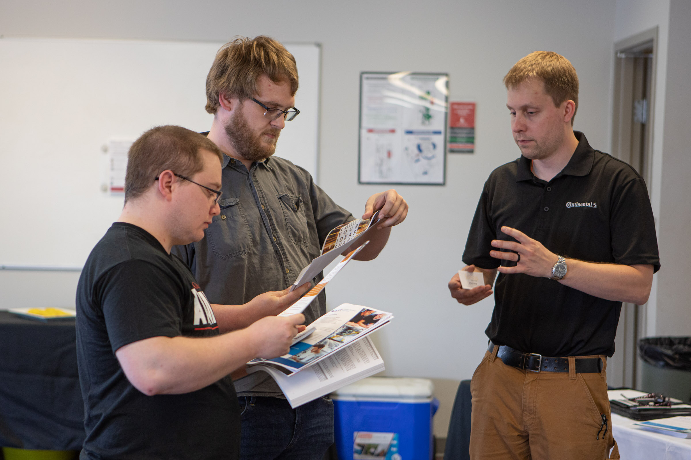 Matthias Kretschmer, CVT Division Engineering Manager with Continental (right), explains the benefits and process of applying for one of the 14 apprenticeship openings to recent graduates, (Left) Shane Hiatt (Mt. Vernon) and (Middle) Alex Bronson (Dix).