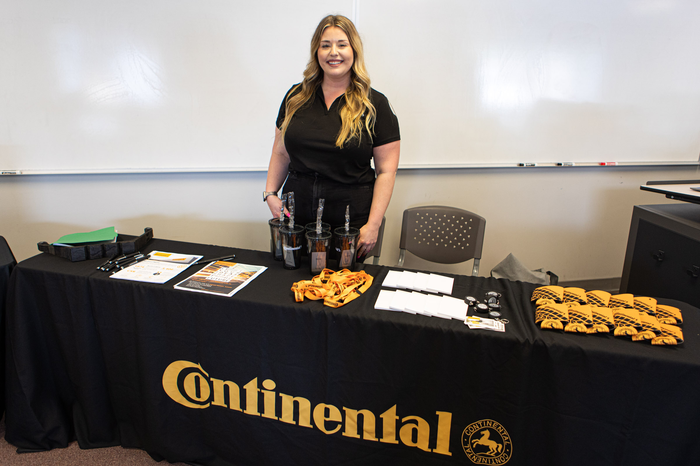 Katelyn Bozarth, HR Business Partner and Human Relations for Continental, displays an information table and giveaways for the ICATT apprenticeship event attendees. 