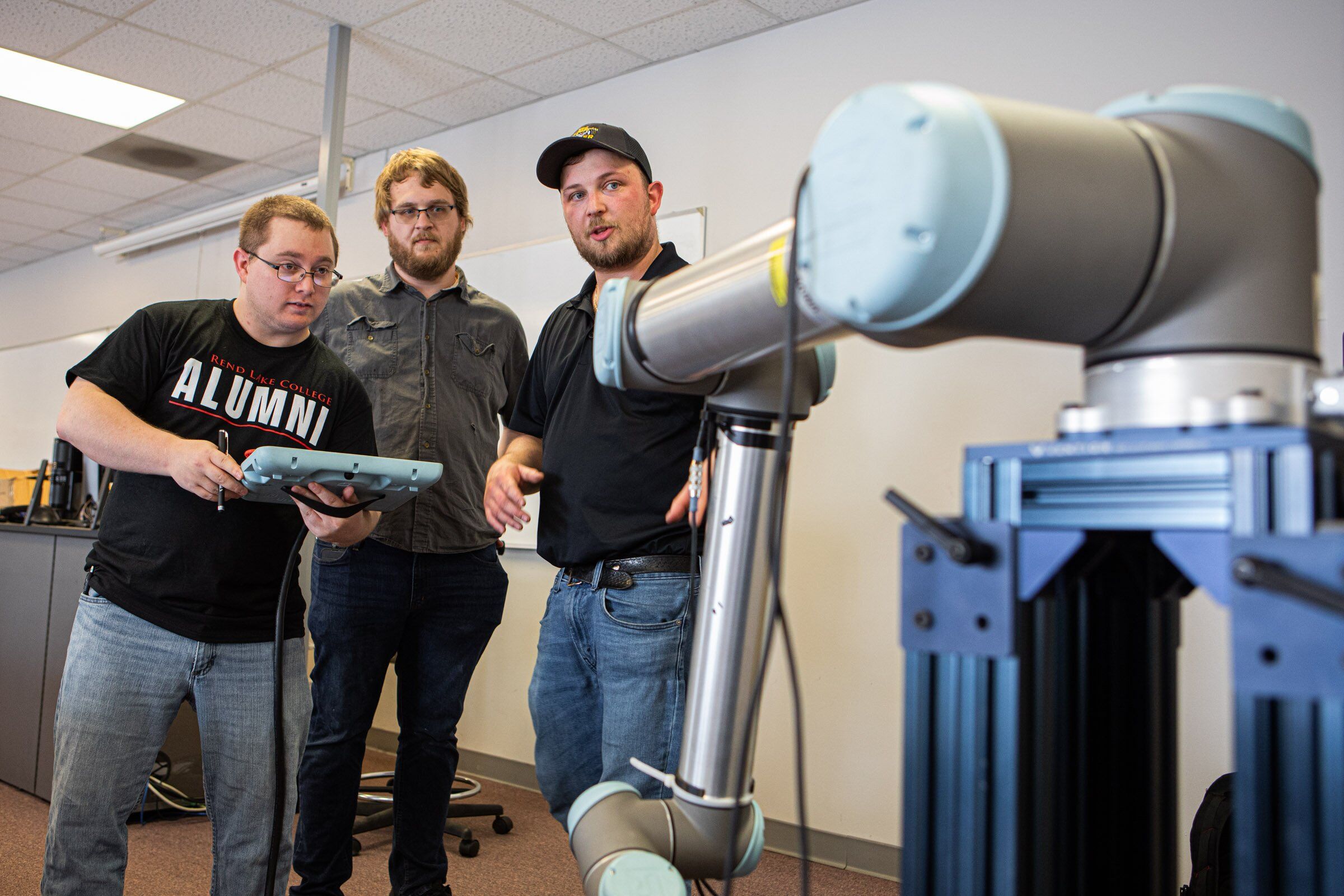 (L-R) Shane Hiatt (Mt. Vernon), Alex Bronson (Dix), and Aubreylee Jones, Continental Tire Systems Specialist, exploring the robot's functions at the ICATT open house. 