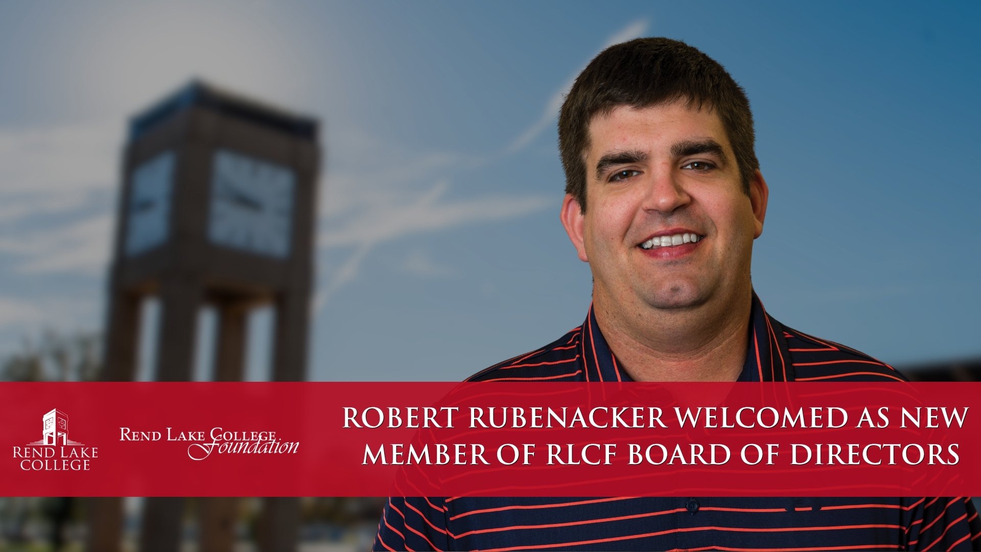 A promotional graphic featuring a headshot of Robert Rubenacker smiling in a striped polo shirt against a blurred background of a blue sky and the Rend Lake College clock tower. A solid red banner runs across the bottom of the image, featuring the Rend Lake College and Rend Lake College Foundation logos on the left. The white text on the right side of the banner reads: "ROBERT RUBENACKER WELCOMED AS NEW MEMBER OF RLCF BOARD OF DIRECTORS".