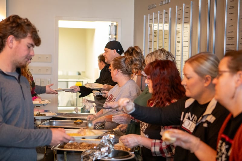 A line of students being served lunch by RLC employees at the November 2025 Lunch on the Lake.