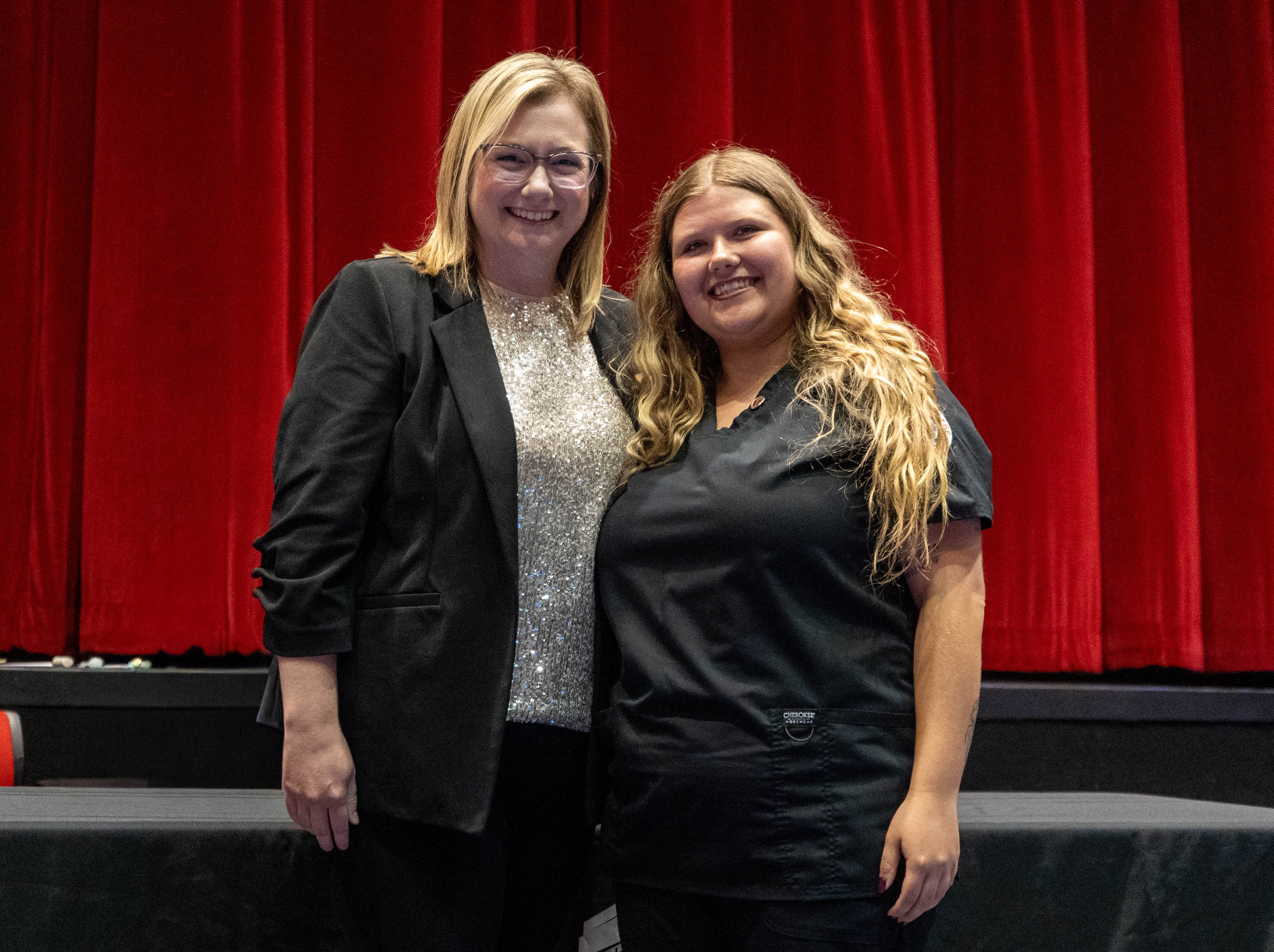 Autumn Baxter (right) receives pin from Sarah Hopfinger (left)