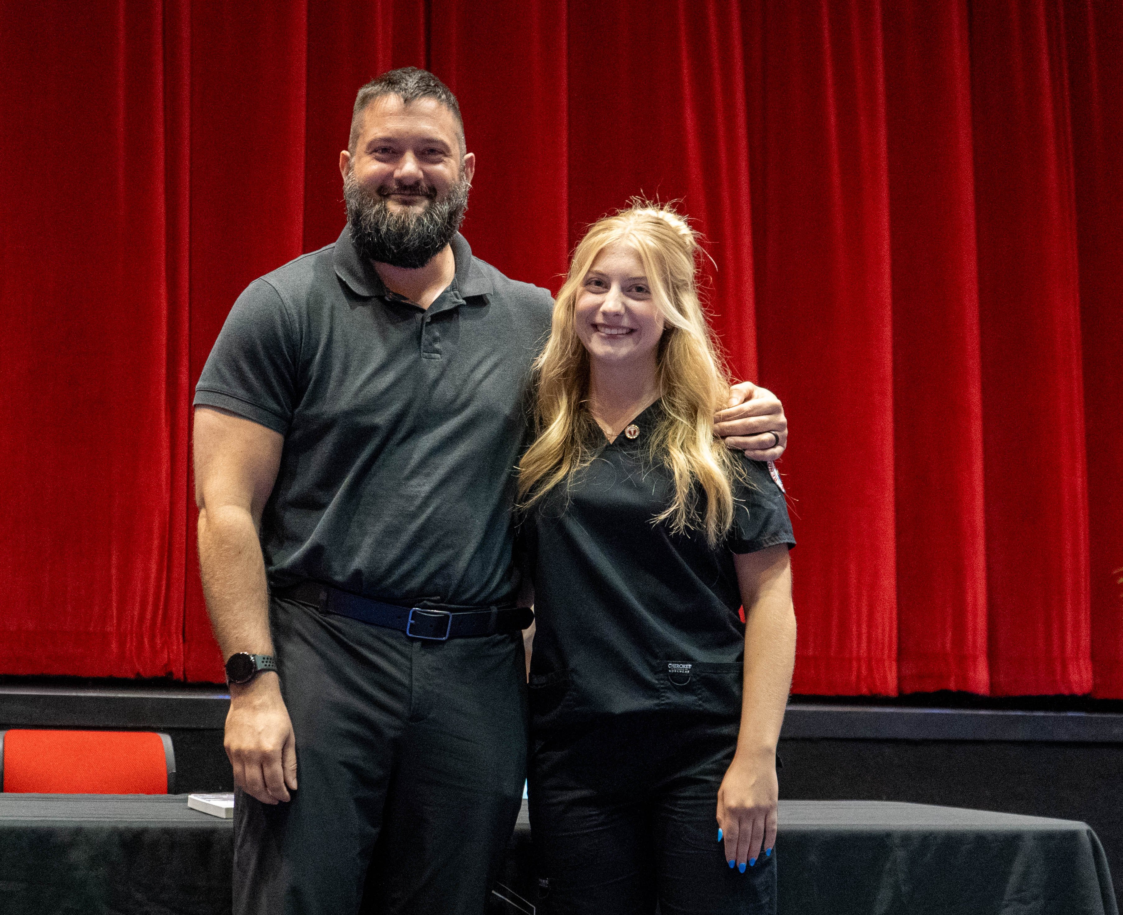 Brylynn Wallace (right) receives pin from Zach Holstetter (left)