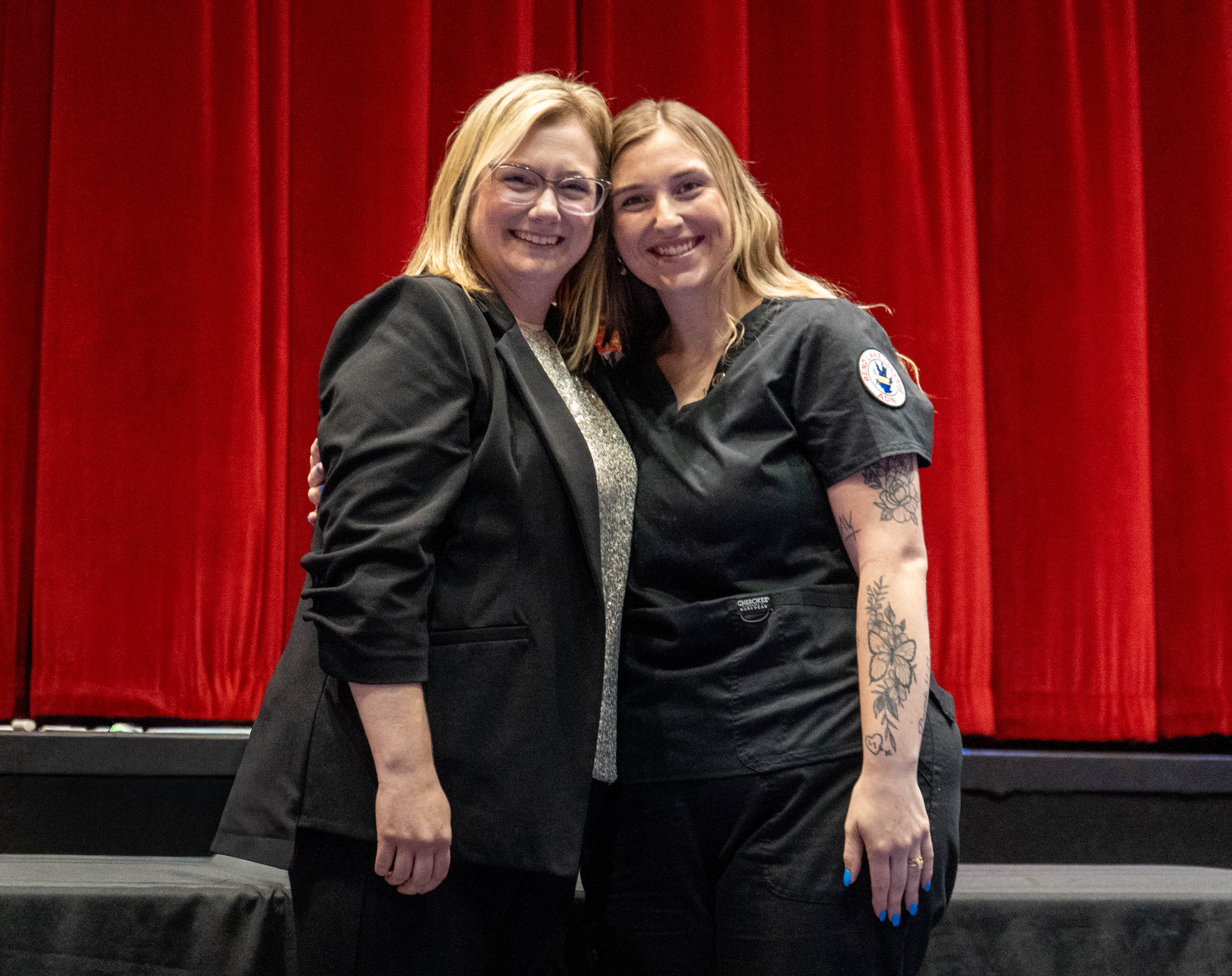Chelsey Greenwalt (right) receives pin from Sarah Hopfinger (left)