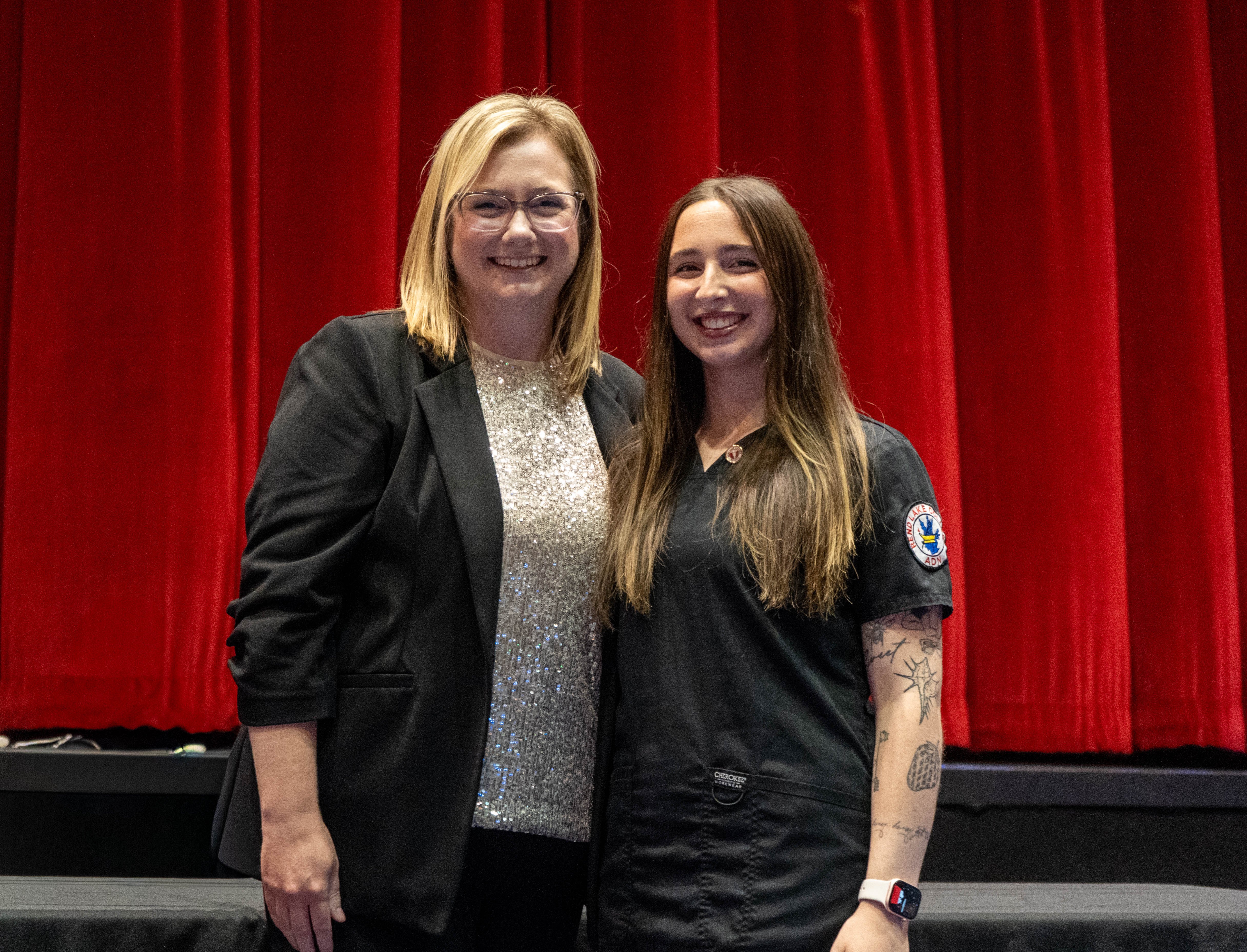 Chloe Jackson (right) receives pin from Sarah Hopfinger (left)