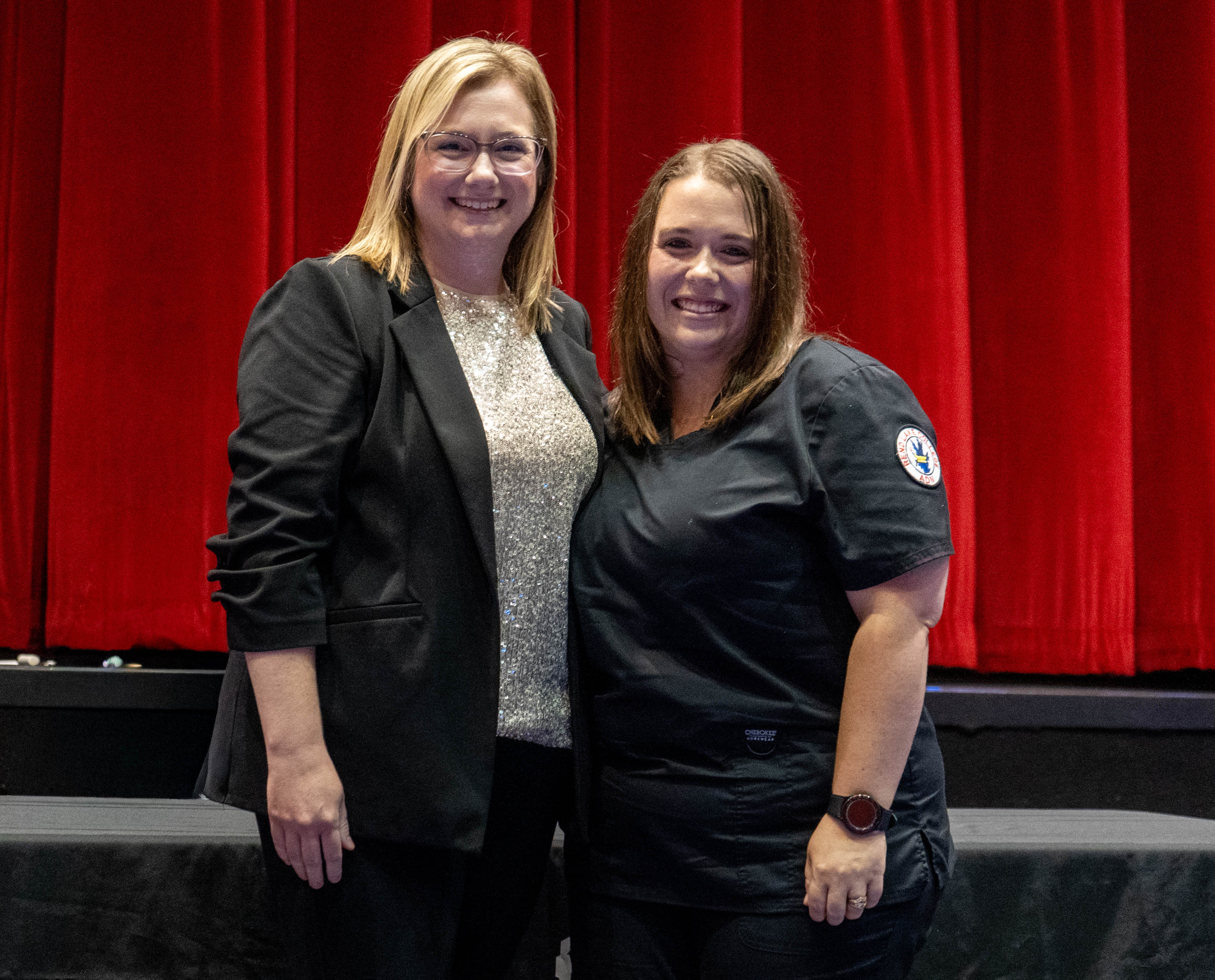 Christy Brooks (right) receives pin from Sarah Hopfinger (left)
