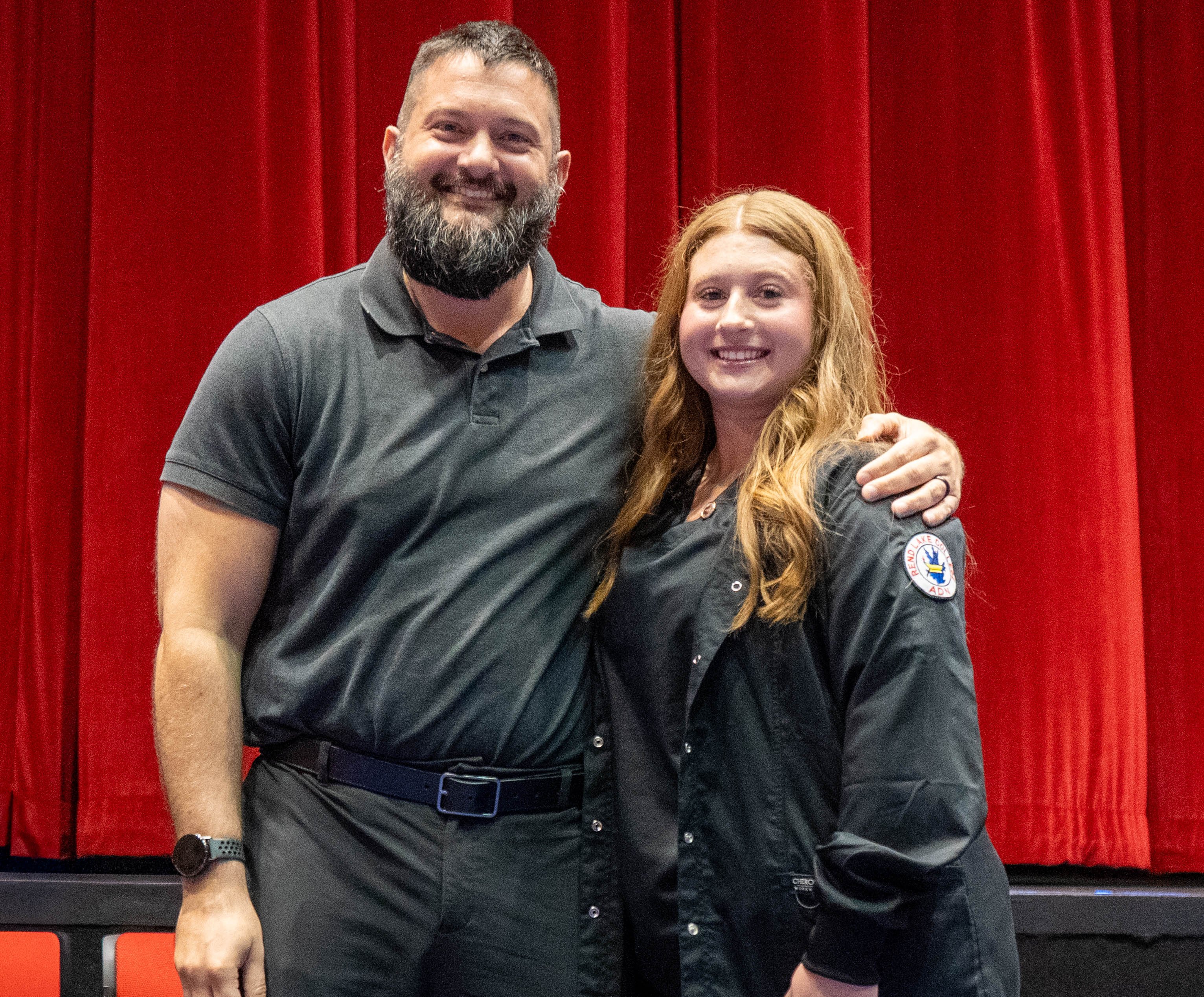 Emily Swan (right) receives pin from Zach Holstetter (left)