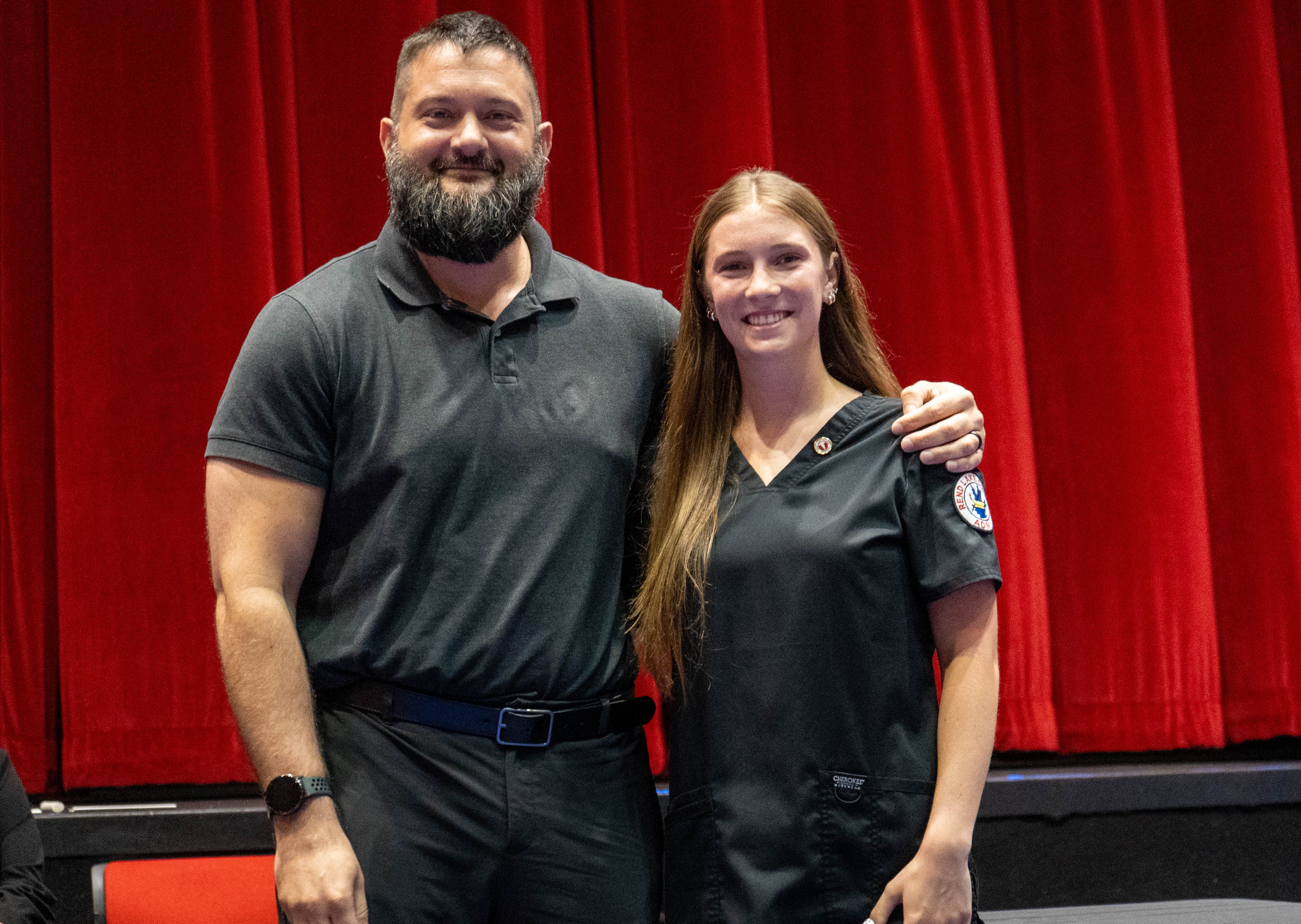 Jessica Marshall (right) receives pin from Zach Holstetter (left)