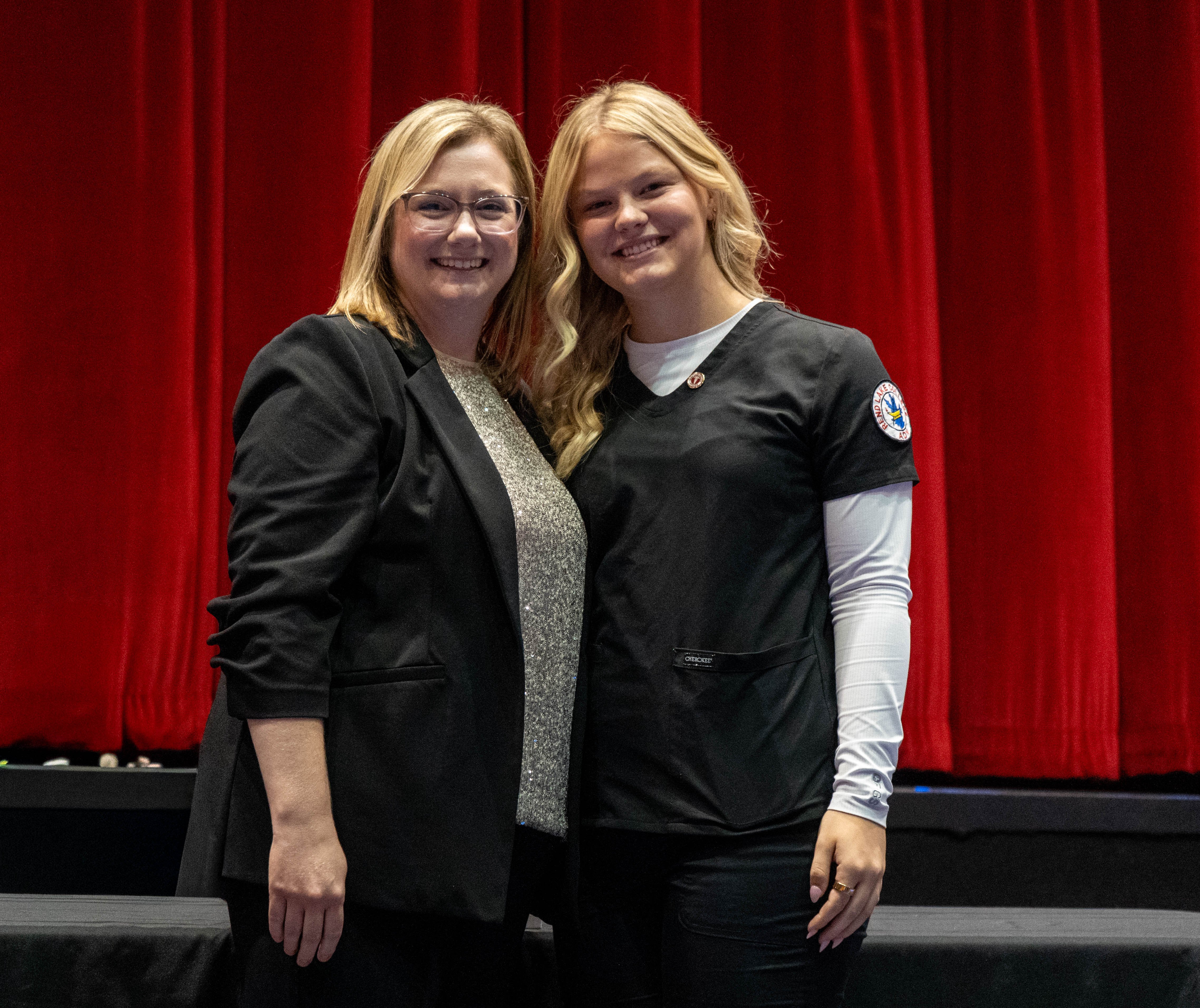 Justice Lanham (right) receives pin from Sarah Hopfinger (left)