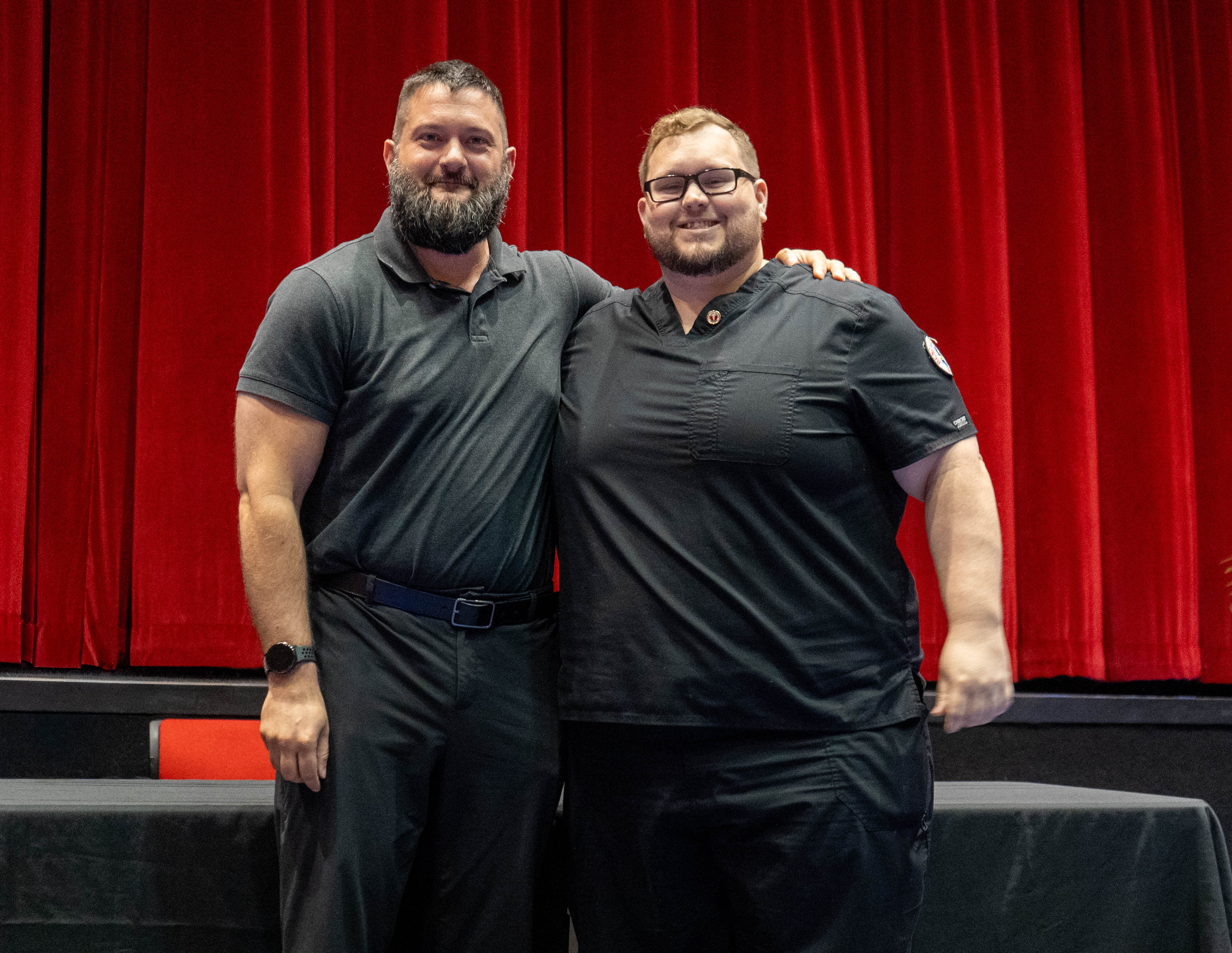Robert Wilkie (right) receives pin from Zach Holstetter (left)