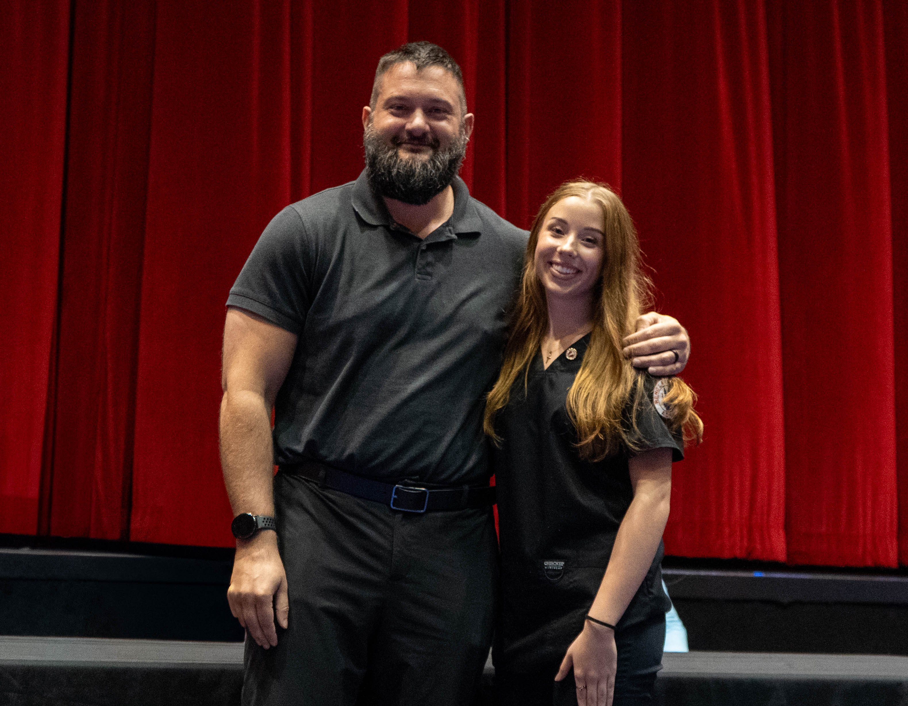 Shelbi Yanez (right) receives pin from Zach Holstetter (left)
