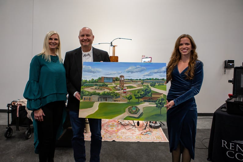 Holly (left) and Steven Tate (middle) with their newly purchased Natsy Art painting with Natalie Hensley (right).