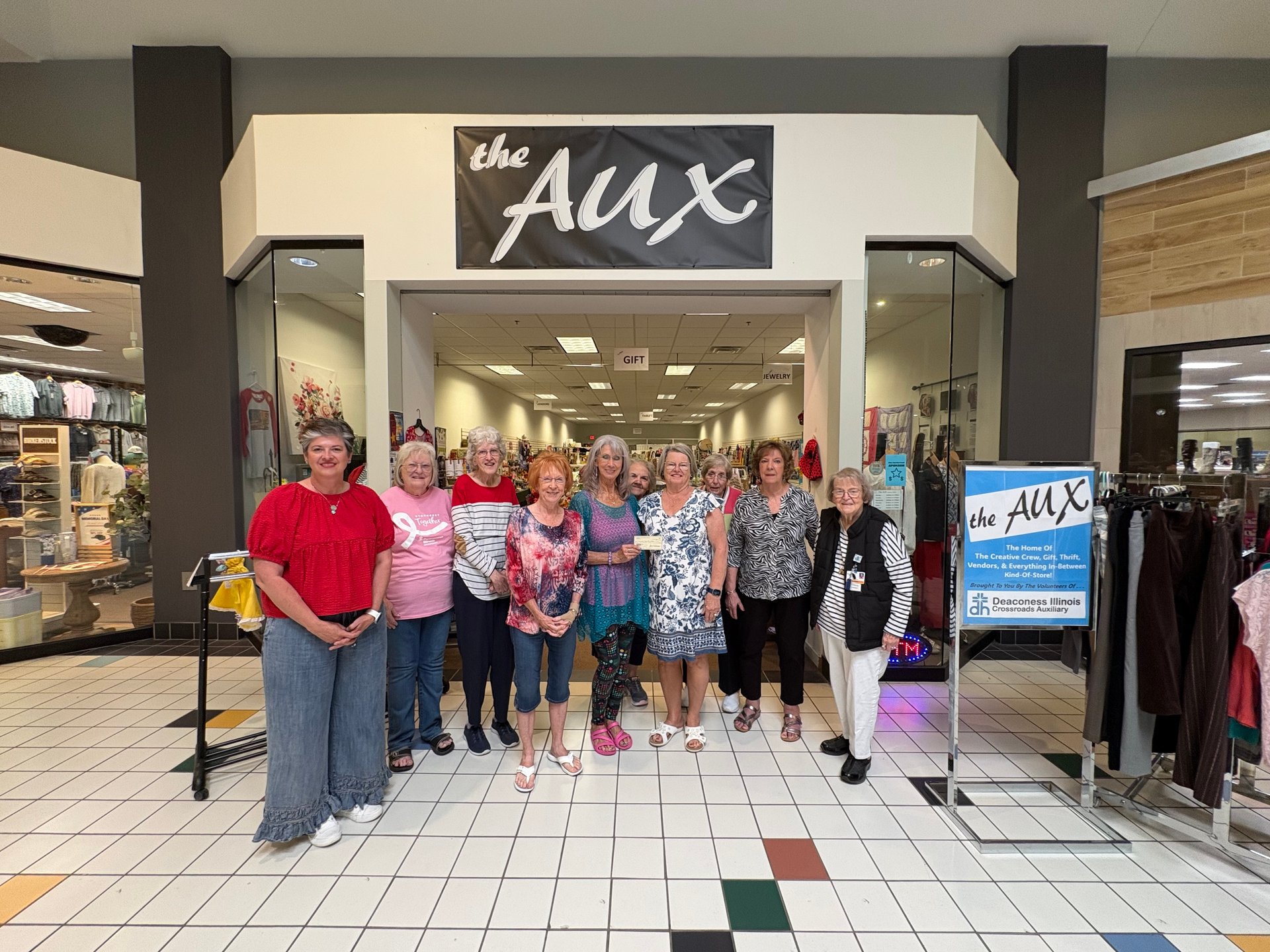 Members of Deaconess IL Crossroads Auxiliary present a check to Rend Lake College Foundation Director Amy Newell (far left) outside their store "the Aux" located at Times Square Mall in Mt. Vernon. 