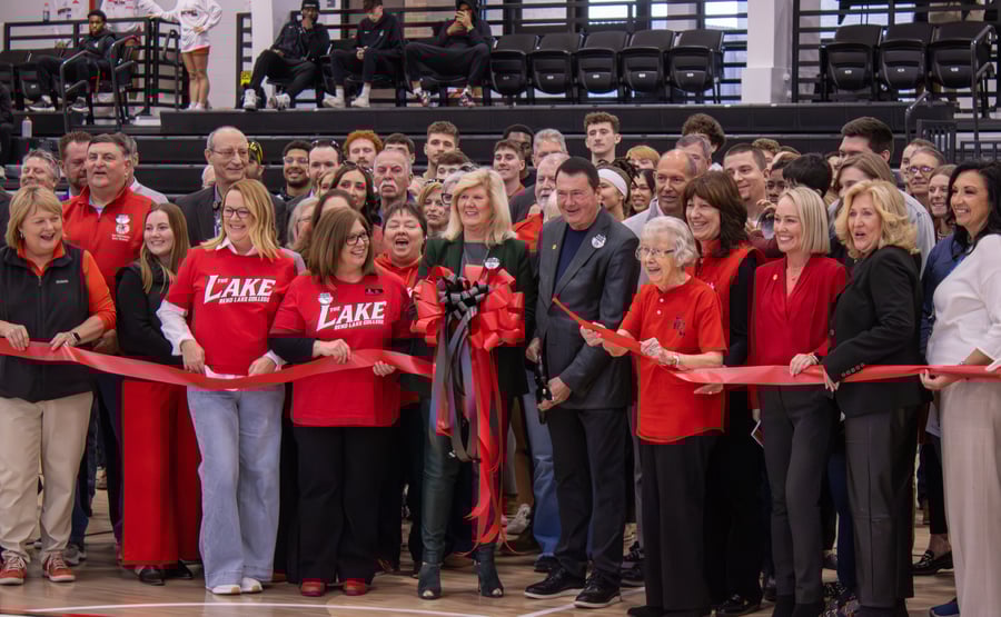 RLC faculty and staff, Banterra Bank representatives, and community members join on the gym floor to celebrate the ribbon cutting for the Banterra Sports Complex.