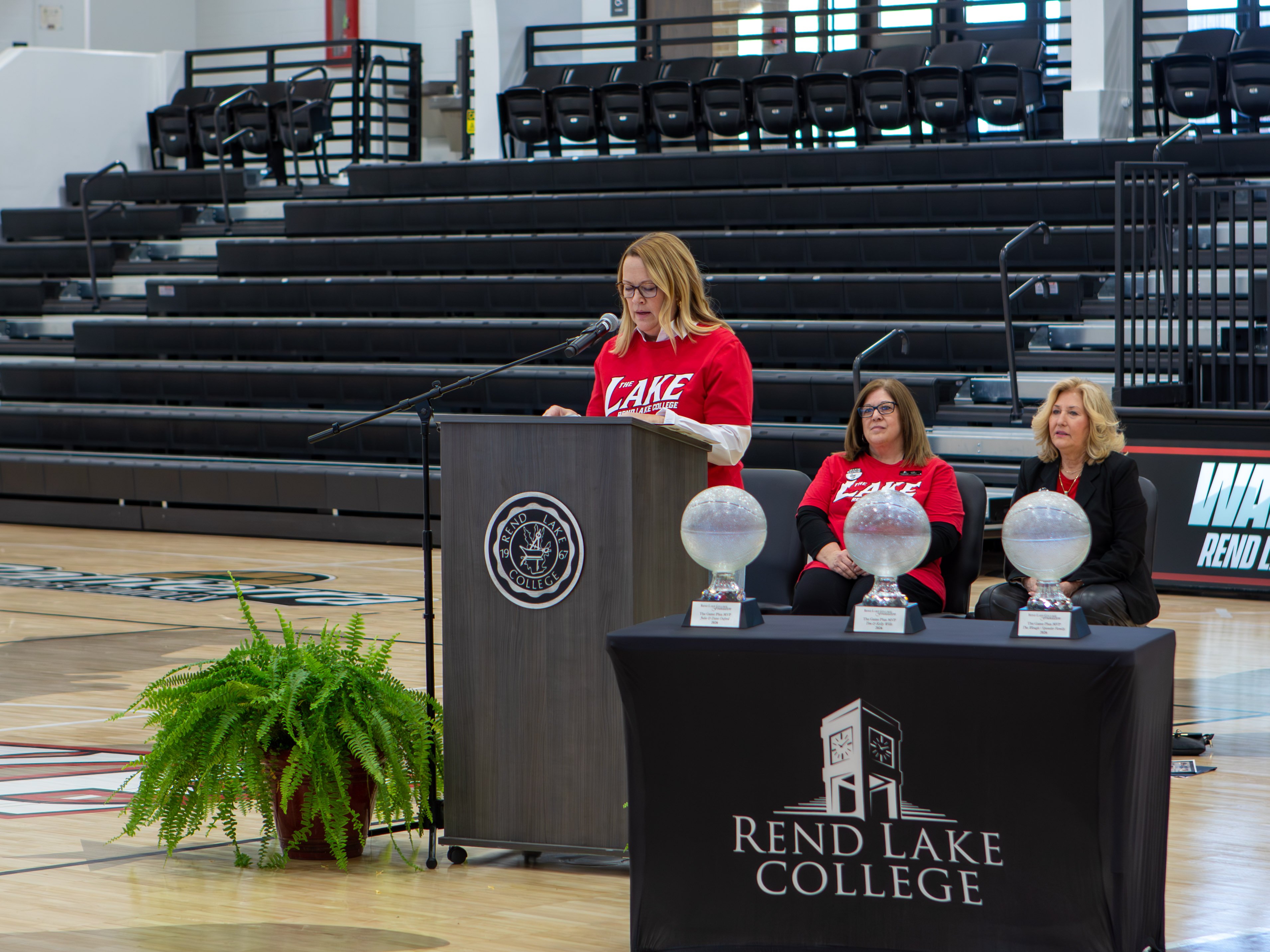Cathy DeJarnette, Executive Director of Administrative Services and The Game Plan Co-Chair, presenting three individuals and families with awards for their recent dedication to the capital campaign.