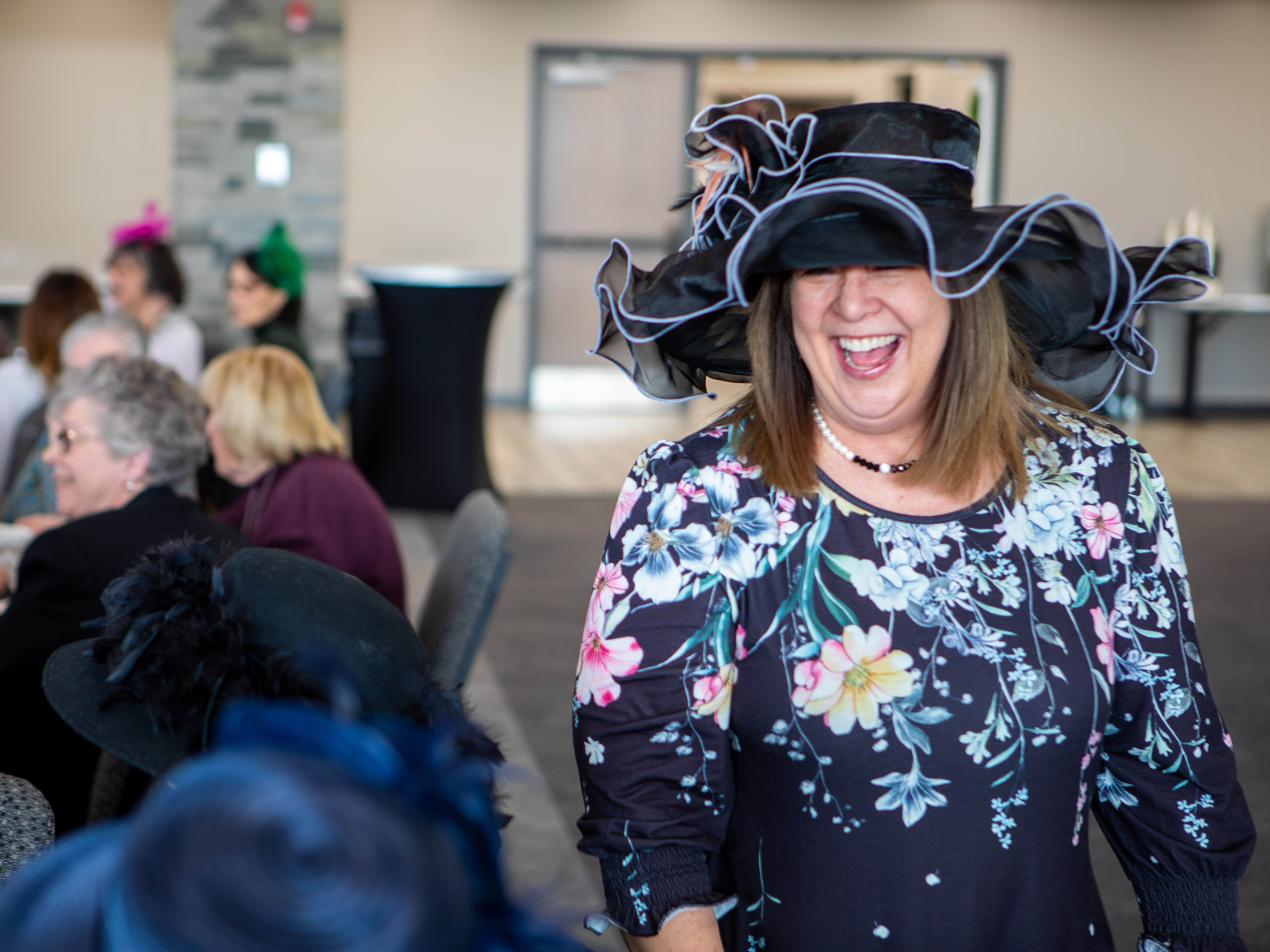 RLC President Lori Ragland laughs during the Wilma Guy High Tea, fully embracing the Kentucky Derby theme.